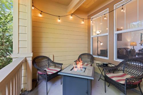 a patio with three chairs and a table with a fire at Old Mill Magic in Bend