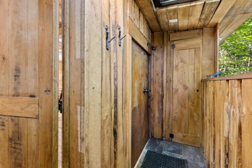 a wooden building with a gate and a door at Amazonia in Rogers