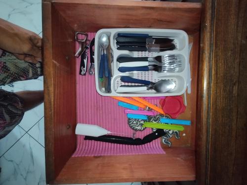 a drawer filled with tools in a wooden box at Suíte Privativa in Paraty