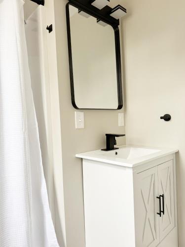 a bathroom with a sink and a mirror on the wall at RiverStone Retreat - Newburgh IN Stylish Apartments in Newburgh