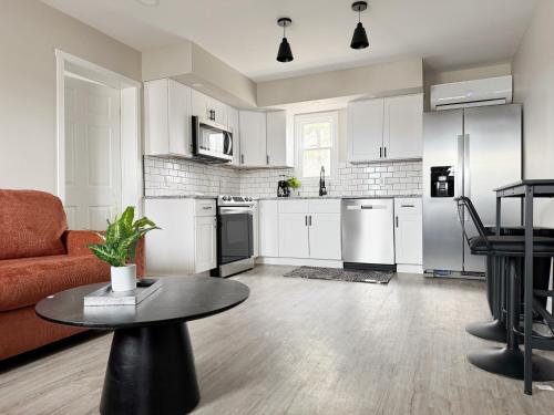 a kitchen with a couch and a table in a room at RiverStone Retreat - Newburgh IN Stylish Apartments in Newburgh