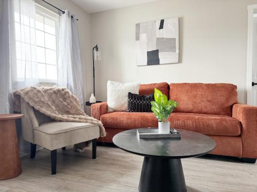 a living room with a couch and a table at RiverStone Retreat - Newburgh IN Stylish Apartments in Newburgh