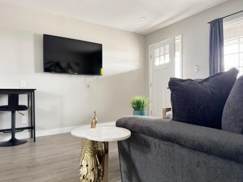 a living room with a couch and a table at RiverStone Retreat - Newburgh IN Stylish Apartments in Newburgh