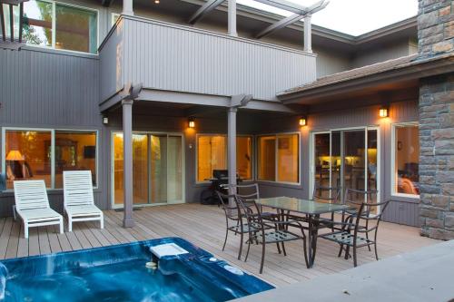 a patio with a table and chairs and a pool at Villa #5 at Broken Top in Bend