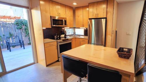 a kitchen with a counter top and a refrigerator at Intimate Townhome Sanctuary DT in Albuquerque