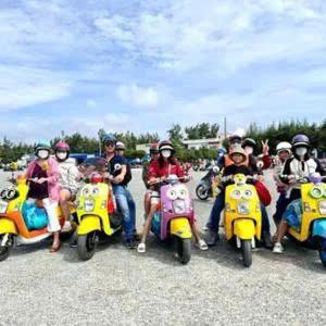 a group of people sitting on motor scooters at Pink Sea Villa in Cu Lao Thu