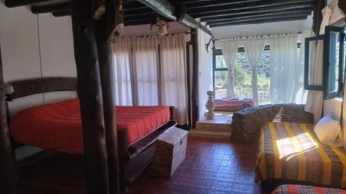 a bedroom with two beds and a couch at Estancia San Pablo in Tupungato