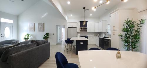 a living room and kitchen with a couch and a table at Orlando Home Vacation near Universal Studios - 3 BR in Orlando