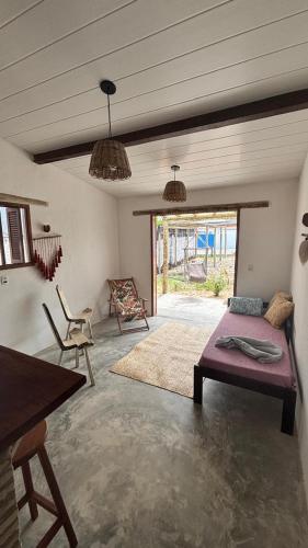 a living room with a couch and a table at Vila PanaPaná in Maxaranguape
