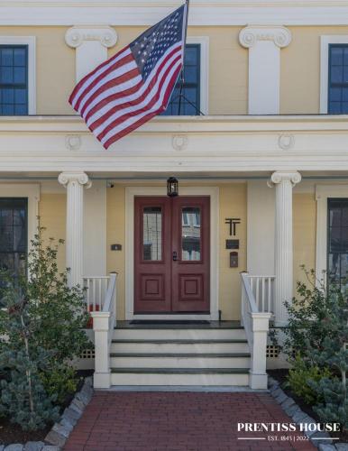 an american flag flying in front of a house at Prentiss House by Thatch in Cambridge