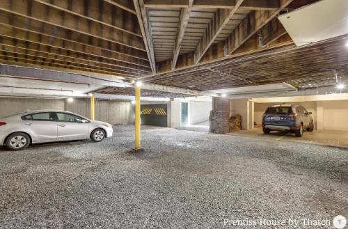 a parking garage with two cars parked in it at Prentiss House by Thatch in Cambridge