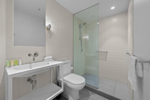 a bathroom with a toilet and a sink and a shower at Unwind with Beautiful Park & Bay Views in Melbourne