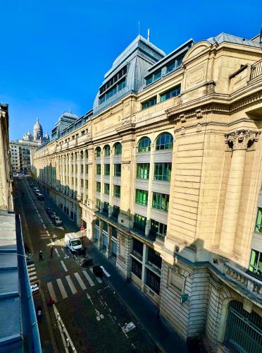 a large building on the side of a street at Hotel Nation Montmartre in Paris