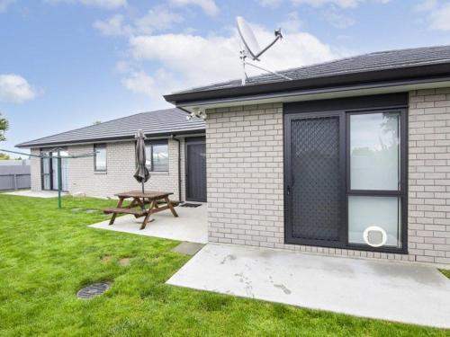 a house with a picnic table in the yard at CareGreen BnB in Napier
