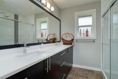 a bathroom with two sinks and a shower at Modern Home in Victoria, BC in Victoria