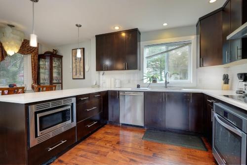 a kitchen with wooden cabinets and a counter top at Modern Home in Victoria, BC in Victoria