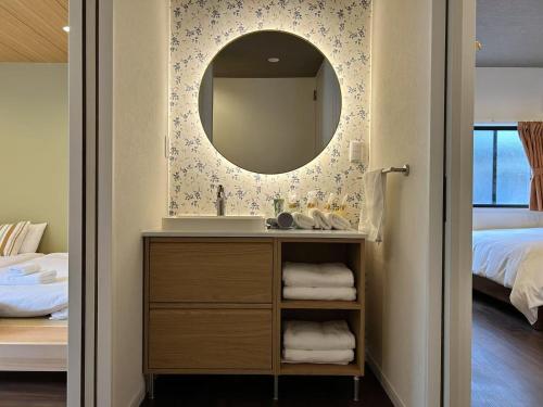 a bathroom with a sink and a mirror at ASOBO OSAKA Kuromon 1st in Osaka