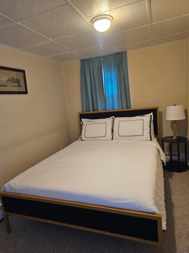 a bedroom with a large white bed with two pillows at Island View House BnB Self Check-In in Portland