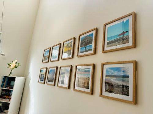 una fila di foto incorniciate su un muro di Central Lorne Gem - Beach & Town Centre at Your Door a Lorne