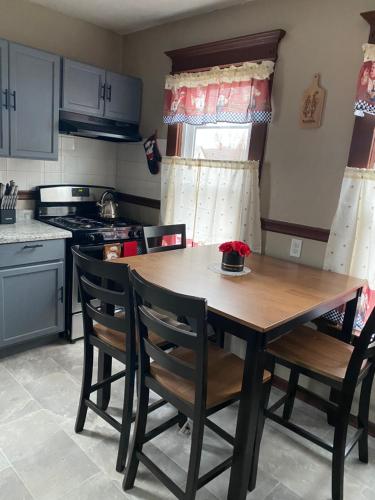 a kitchen with a wooden table and two chairs at Casa ubicada 6 minutos del centro 6 minutes to Downtow No permited partys or smoking in Milwaukee