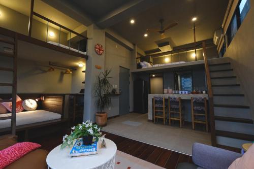 a room with a bunk bed and a living room at Lux Sea Studio 1 in San Juan