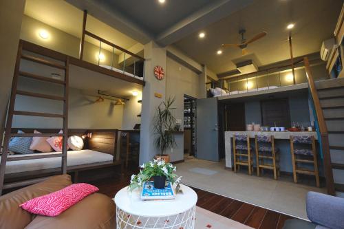 a room with bunk beds and a living room at Lux Sea Studio 1 in San Juan