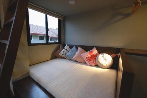 a small bed in a small room with a window at Lux Sea Studio 1 in San Juan