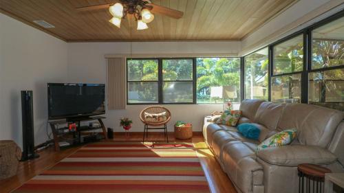 a living room with a couch and a flat screen tv at HSS1480 in Englewood
