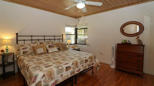 a bedroom with a bed and a dresser and a mirror at HSS1480 in Englewood