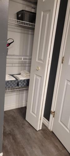 an open door to a room with a closet at Rustyc Charm Meets Modern Comfy in Dieppe