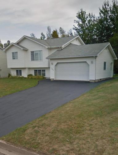 a white house with a large driveway at Rustyc Charm Meets Modern Comfy in Dieppe