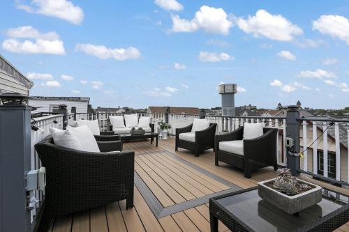 a deck with chairs and a table on a balcony at The Inn At Ocean Grove in Ocean Grove