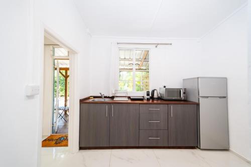 a kitchen with a refrigerator and a counter top at Bleu de Toi Boutique Hotel in Grand Baie