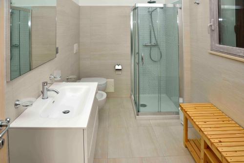 a bathroom with a shower and a sink and a toilet at Spazi Preziosi in Torre San Giovanni Ugento
