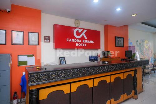 a bar in a restaurant with a sign on the wall at Hotel Candra Kirana Syariah Prawirotaman Yogyakarta Mitra RedDoorz in Yogyakarta