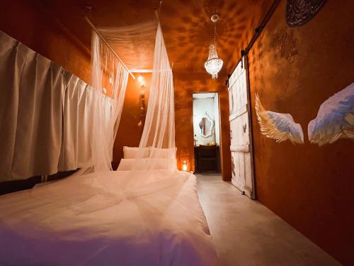 a bedroom with a large white bed in a room at villa Morocco in Nagasaki