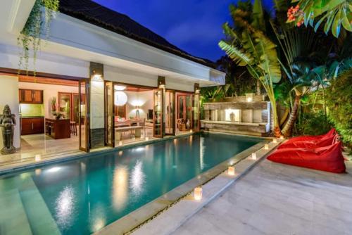 a swimming pool in the backyard of a villa at The Residence Seminyak in Seminyak
