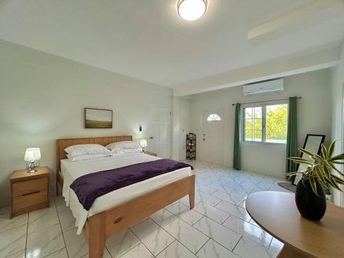 a bedroom with a large bed and a table at Oleander in Port Elizabeth