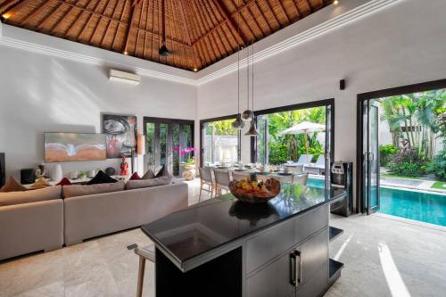 a living room with a couch and a table at The Residence Seminyak in Seminyak