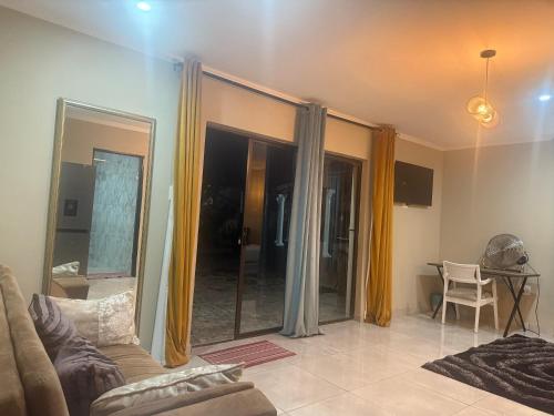 a living room with a couch and a table at Horizon Bed and Breakfast in Roodepoort