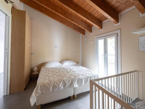 a bedroom with a bed with a white comforter at Apartment in Vignone with Lake Maggiore Views in Vignone