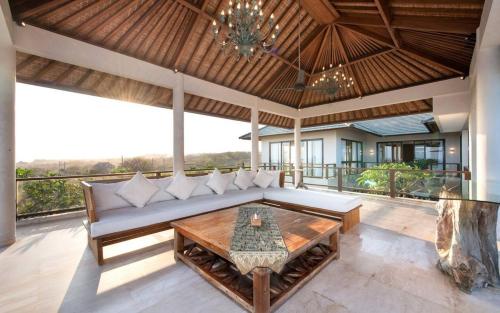 a living room with a couch and a table at Karang Saujana in Uluwatu