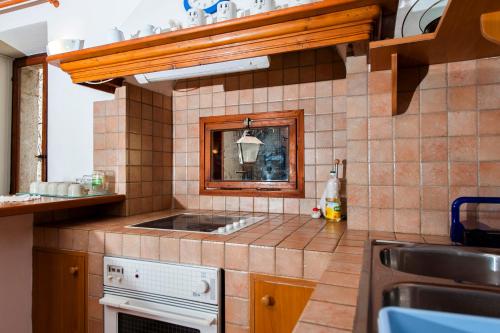 a small kitchen with a sink and a stove at Apartment Marconi in Rovinj