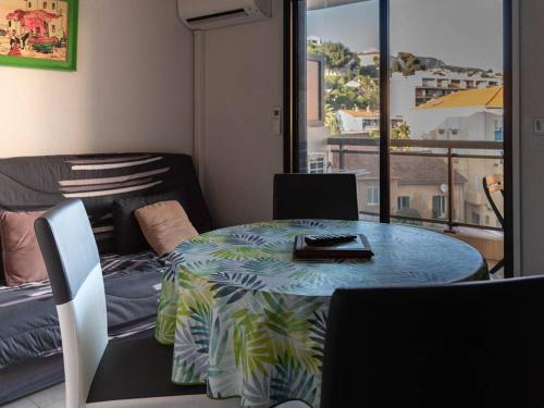 Cette chambre dispose d'un balcon avec une table et des chaises. dans l'établissement T2 + cabine au Lavandou, proche plage, climatisation, parking privé - FR-1-803-19, au Lavandou