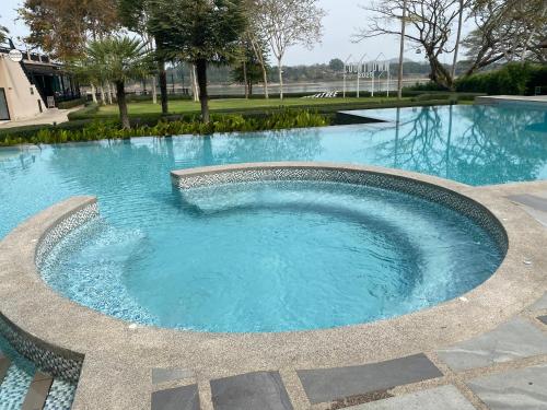 a large swimming pool with blue water at River Tree Resort in Chiang Khan