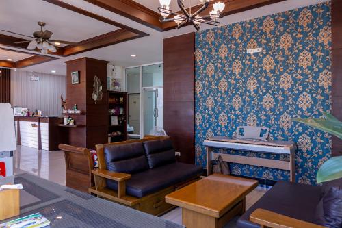 a living room with a chair and a fireplace at Panwalee Hotel in Khon Kaen