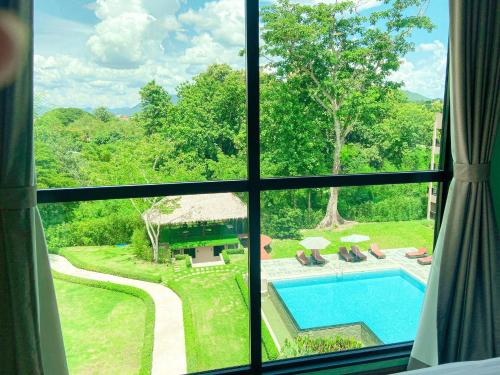 a view of a pool from a window at River Tree Resort in Chiang Khan