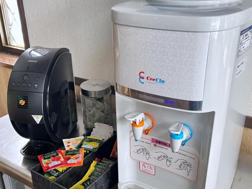 a refrigerator with a coffee maker on top of it at Villa Zoo in Nanto