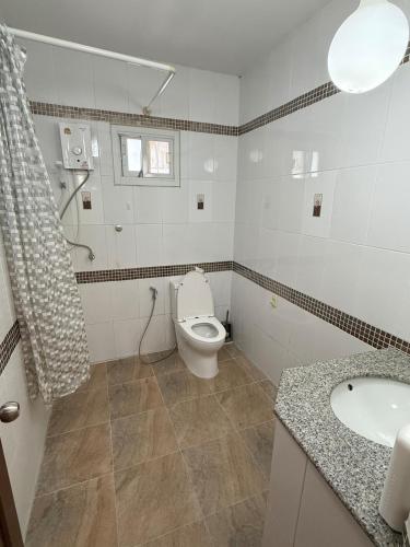 a bathroom with a toilet and a sink at G warmth Pool Villa in Pattaya South