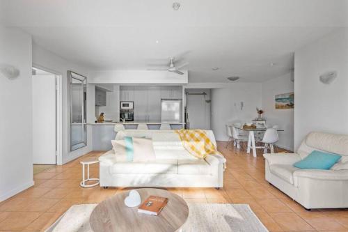 a living room with two white couches and a table at The Rocks Resort Unit 2i in Gold Coast